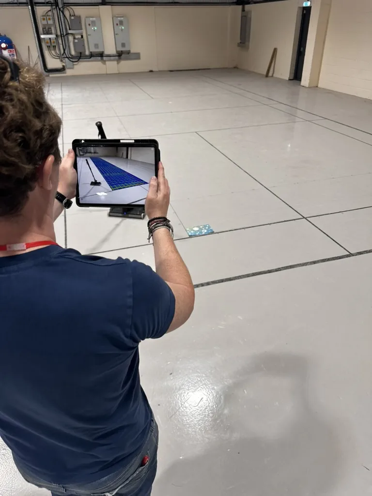 Surveyor reviewing the GPR scan data live on a tablet, with the scan grid overlaid on the Dartford slab in augmented reality