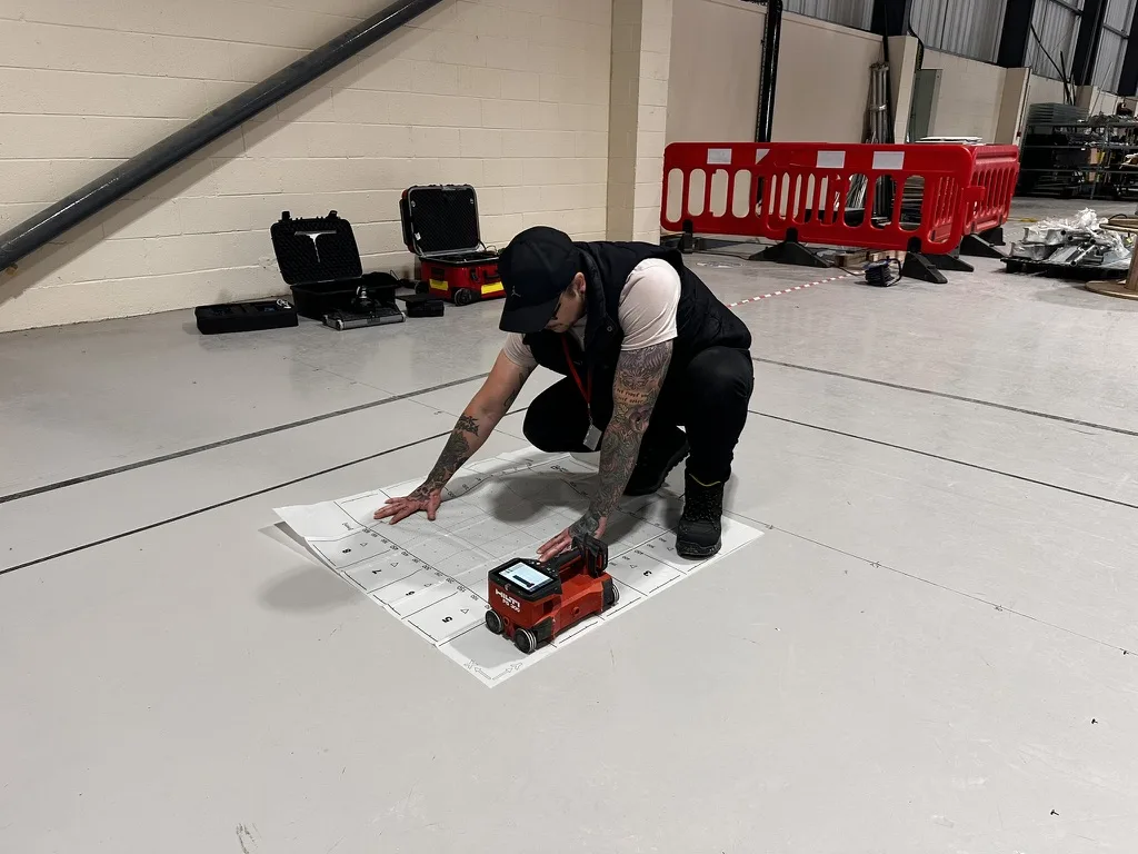 Corvus surveyor setting out a gridded scan area on the slab with a Hilti scanner at Custodian Data Centres, Dartford