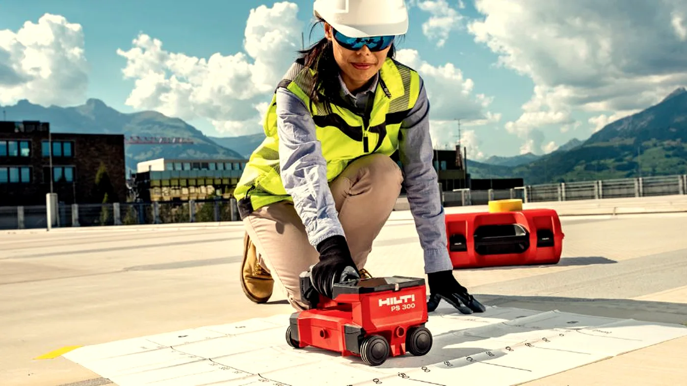 Operative using Hilti PS300 to scan an outdoor concrete structure for embedded services