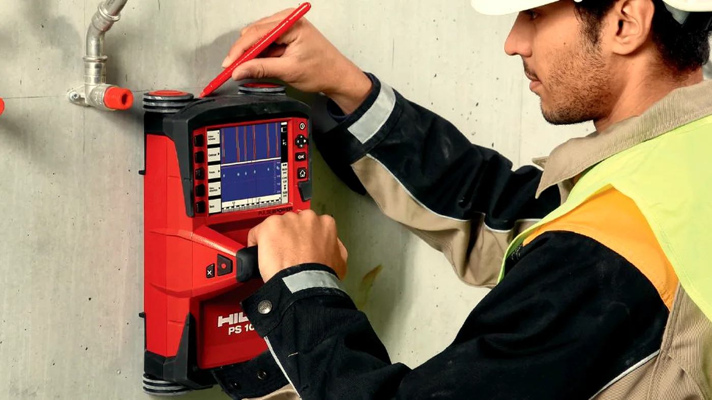 Engineer reviewing live GPR data on a Hilti PS1000 scanner display during a structural survey