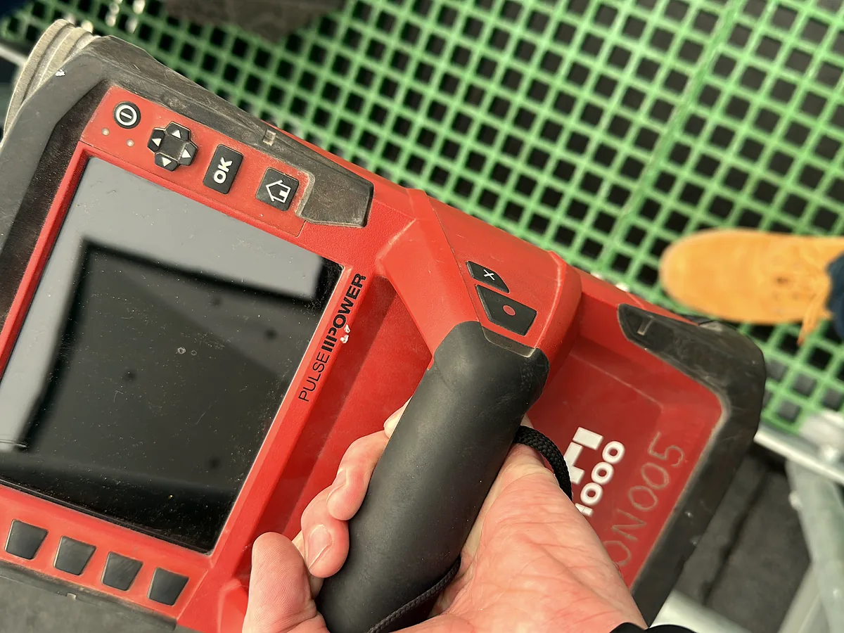 Surveyor operating a Hilti PS1000 ground-penetrating radar scanner on site